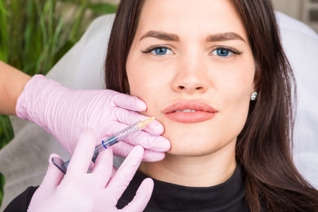 young beautiful woman having Injectable filler in her lips. Professional cosmetology. anti-aging skin care. Beautiful girl