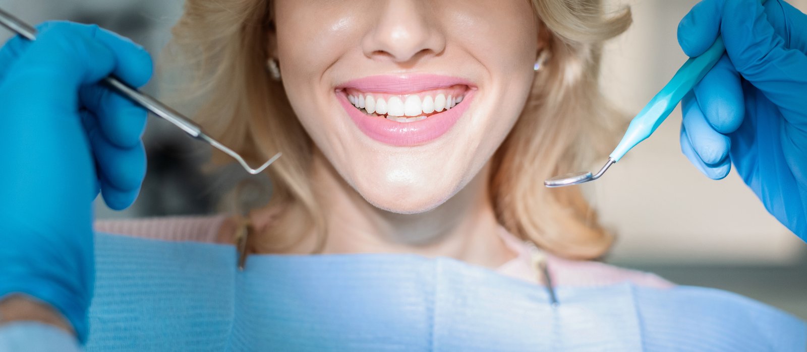 Patient comparing composite bonding and porcelain veneers options at a dental consultation